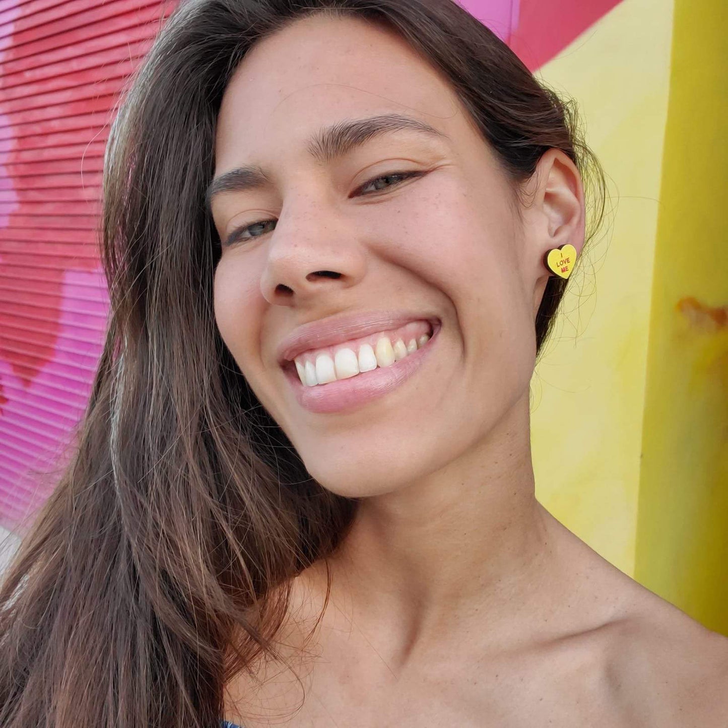 Girl wearing Feminist Candy Heart Studs