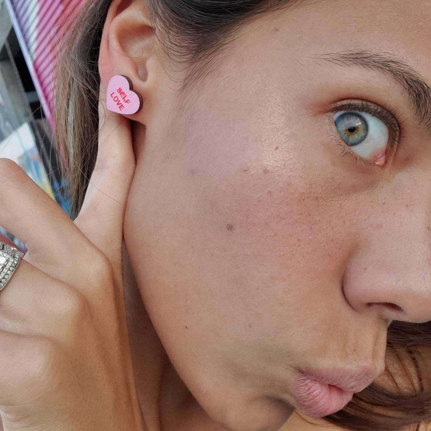 Girl wearing Feminist Candy Heart Studs