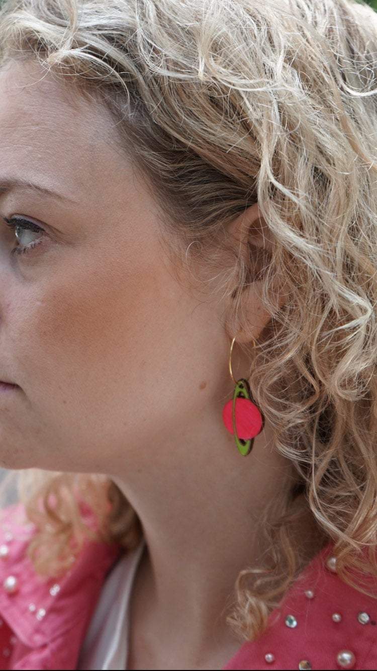 Girl Wearing Neon Saturn Hoops Earrings