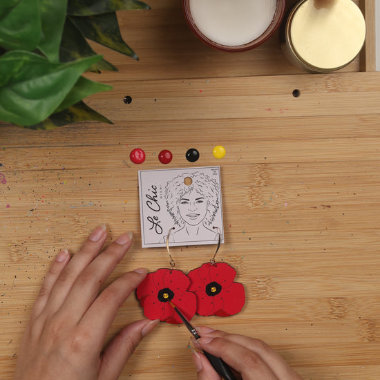 red poppy earring being hand painted - le chic Miami